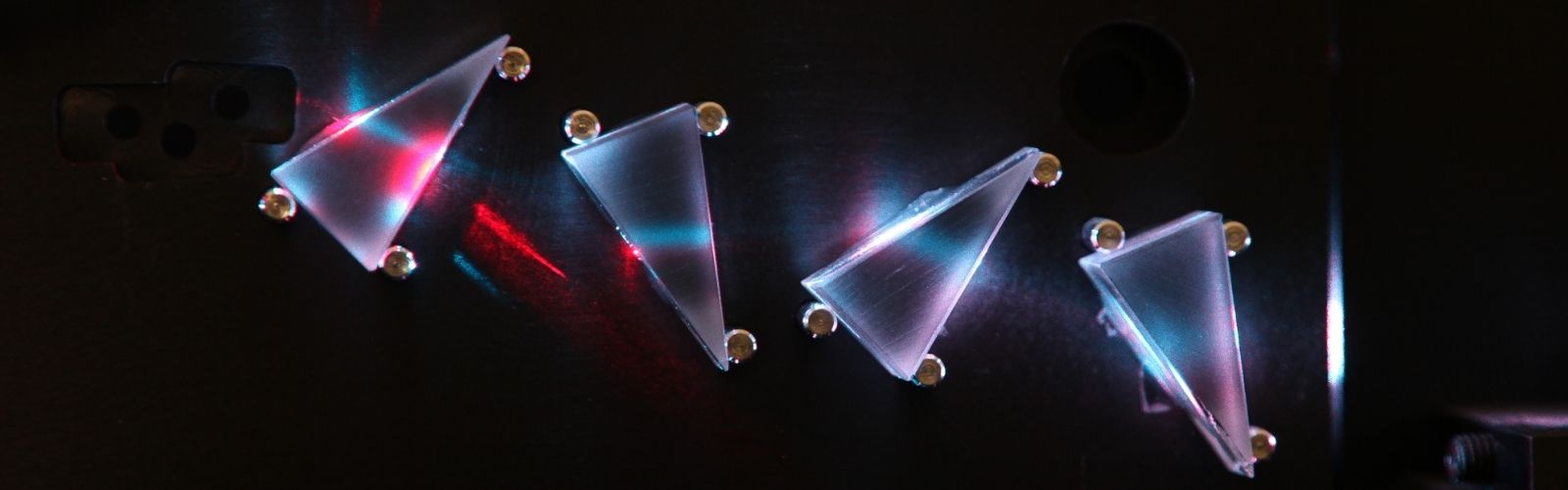 Light shining through prisms of a flow cytometer