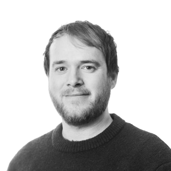 A headshot of James Gilmore, in black and white, with a white background.